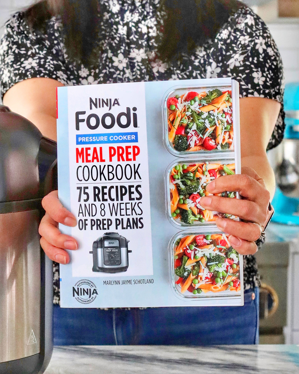 http://www.marlynnschotland.com/wp-content/uploads/2022/02/hands-holding-the-Ninja-Foodi-cookbook.jpg